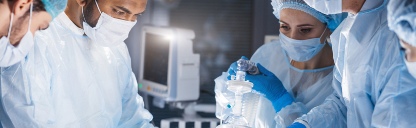 team of surgeons working on a patient in operating room