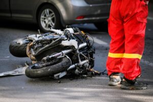 Motorcycle vs car accident happening along the highway.