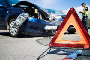 Warning sign at car accident in the road