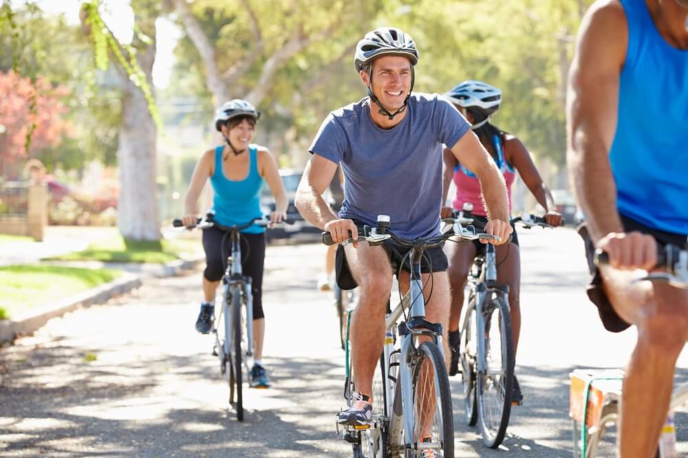 Group of cyclists wearing helmet for safety.