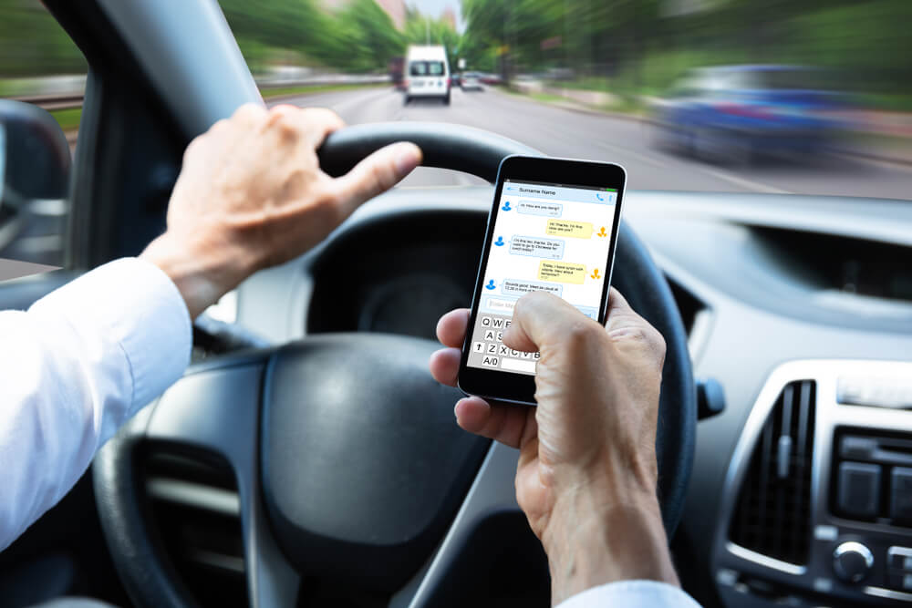 Driver is texting while driving.