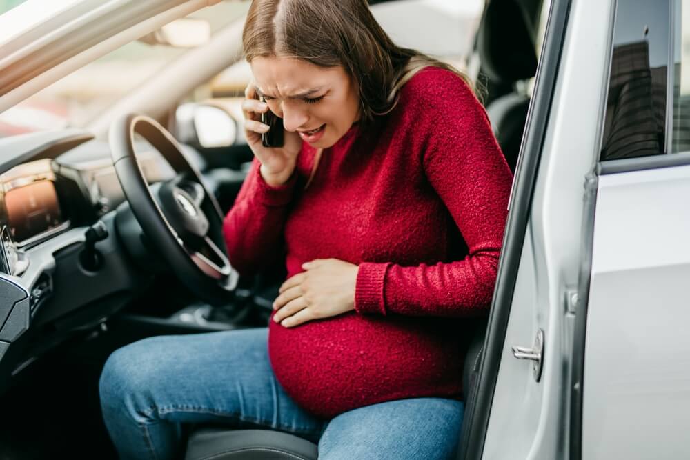 Pregnant driver suffering miscarriage from car accident.