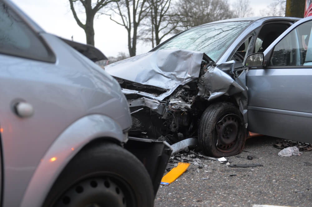 Car damages from collision along the road