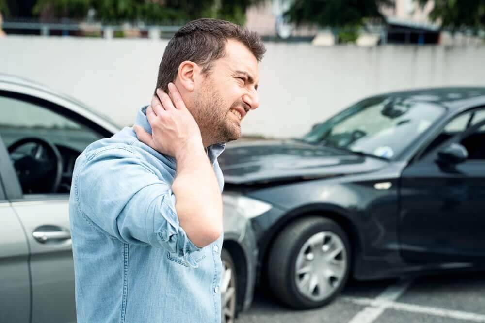 Driver feeling pain after accident suffering whiplash.